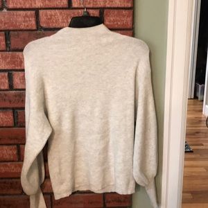 Sandy white turtle neck with bell sleeve